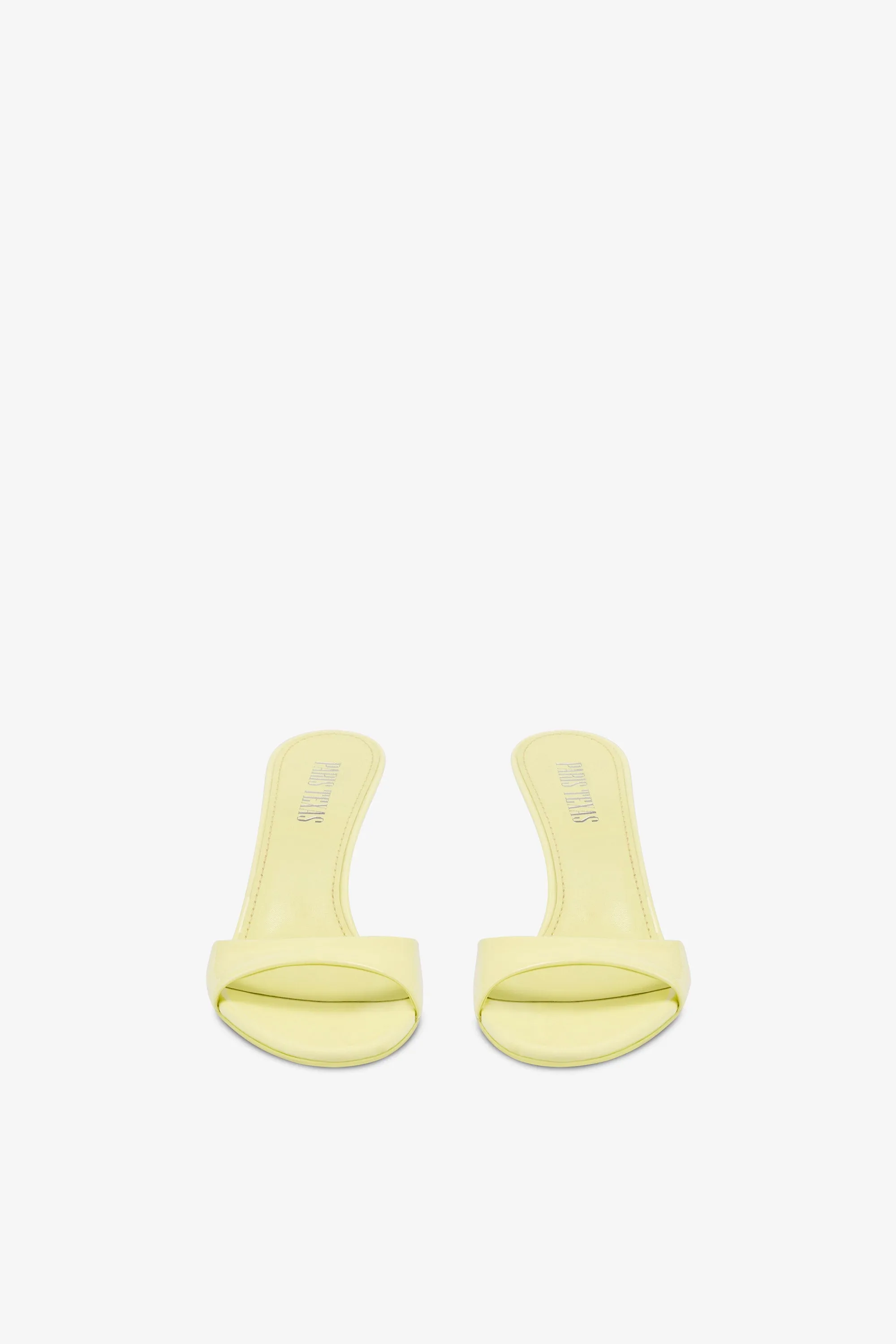Mules in light yellow patent leather